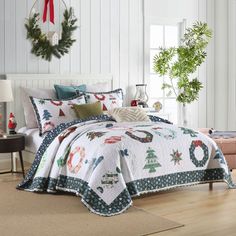 a christmas themed bedroom with white walls and wood flooring, decorated for the holidays