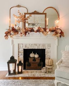 a living room with a fireplace decorated for fall