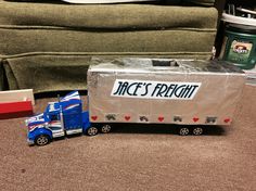 a toy truck is next to a cardboard box with the word race's freight on it