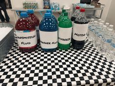 several bottles of water sitting on top of a checkered table