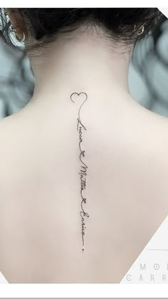 the back of a woman's neck with a tattoo that reads, i love you