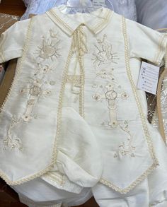 BOYS BAPTISM Choose between our ivory gown or White gown. Beautiful Handmade Boy Baptism Christening Romper Outfit. Romper with hand stitched beading on sleeves and shirt center. Shirt has button back and beautiful collar. Boy romper pants with beautiful detail and elastic on waist to insure perfect fitting.  short sleeve  shirt . Matching hat. White Embroidered Baptism Dress For Ceremony, Fitted Embroidered Sets For Baptism, Cream Long Sleeve Baptism Set, Elegant Embroidered Baptism Sets, Fitted White Baptism Dress With Pearl Embroidery, White Embroidered Baptism Sets, White Embroidered Sets For Baptism, Traditional White Baptism Sets, Fitted White Sets With Pearl Embroidery