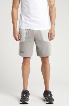 PUMA and LA-based label PLEASURES collaborate on these comfy cotton French terry sweat shorts done in a cool colorblock style with neon trim. 8" inseam; 25" leg opening; 13" front rise; 16 1/2" back rise (size Medium) Elastic/drawstring waist Front welt pockets 70% cotton, 30% recycled cotton Machine wash, tumble dry Imported PUMA has received the Fair Labor Association accreditation, which signifies that the company has effective systems and procedures in place to successfully uphold fair labor standards throughout its supply chains, including strategies and tools to address and improve working conditions Gray Cotton Summer Activewear, Gray Sportswear Shorts For Streetwear, Gray Cotton Athletic Shorts For Loungewear, Sporty Gray Cotton Shorts, Gray Cotton Athleisure Shorts, Gray Cotton Athletic Shorts For Gym, Gray Cotton Sportswear Shorts, Gray Relaxed Fit Sporty Shorts, Cotton Athletic Shorts With Pockets For Gym