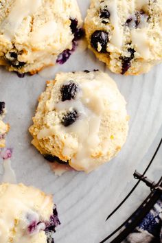 blueberry muffins with icing on a plate