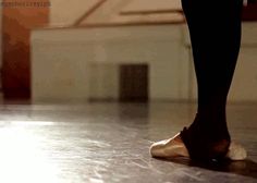 a person's feet in ballet shoes on the floor