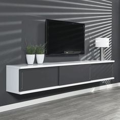 a flat screen tv sitting on top of a white entertainment center