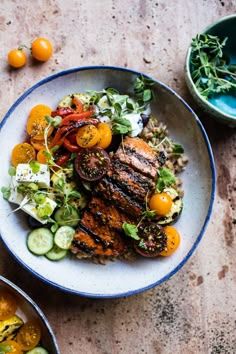 two bowls filled with food on top of a table