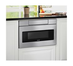 a stainless steel microwave oven in a kitchen