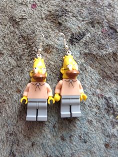 two lego figures are sitting on the ground