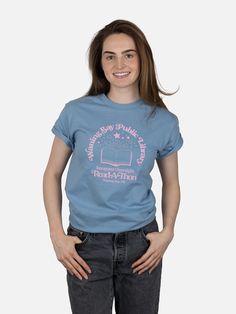 Waning Bay Public Library Inaugural Overnight Read-A-Thon unisex t-shirt - from Funny Story by Emily Henry. Product Details 100% heavyweight cotton tee Shirt color: stone blue Text color: pink This tee uses puff ink in the graphic to add dimension to the design. Size & Fit Available in S-3XL Bookish T-shirt With Letter Print And Crew Neck, Bookish Crew Neck T-shirt With Graphic Print, Bookish Cotton T-shirt With Custom Print, Relaxed Fit Pre-shrunk Bookish T-shirt, Read A Thon, Emily Henry, Blue Text, Funny Story, Color Stone