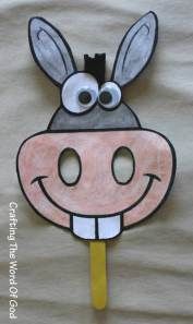 a paper cow mask with googly eyes and a toothpick sticking out of it's mouth