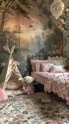 a child's bedroom with a teepee tent and pink flowers on the wall