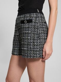 Woven boucle tweed shorts High rise, sits at natural waist Faux front pockets. Back welt pockets. Removable layered chain belt detail Denim waistband Side zip closure 3.25" inseam Measurements taken from a size S 70% Recycled Polyester, 12% Cotton, 9% Viscose/Rayon, 4% Polyamide/Nylon, 2% Metalized Fiber/Metallic, 2% Acrylic, 1% Wool. Contains recycled plastic. Chic Black Tweed Bottoms, Short Tweed Bottoms For Work, Chic Tweed Shorts, Casual Tweed Shorts, Spring Tweed Shorts, Tweed Shorts, Layered Chain, Viscose Rayon, Chain Belt