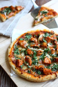 a pizza sitting on top of a wooden cutting board