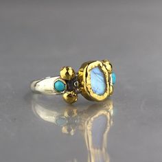 Moonstone Wedding Ring, Gold Moonstone Ring, Silver and Gold Ring, Mixed Metal Ring, Multistone Ring, Turquoise Ring, Wearable Art by yifatbareket on Etsy https://www.etsy.com/listing/290776705/moonstone-wedding-ring-gold-moonstone Moonstone Wedding Ring, Silver And Gold Ring, Mixed Metal Ring, Wedding Ring Gold, Gold Moonstone Ring, Mixed Metal Rings, Peridot Jewelry, Ring Turquoise, Garnet Jewelry