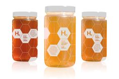 three jars of honey with labels on them