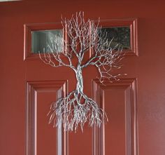 a door with a metal tree on it