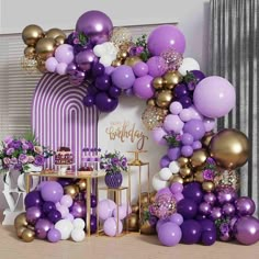 a purple and gold birthday party with balloons