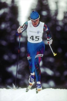 a man riding skis down a snow covered slope