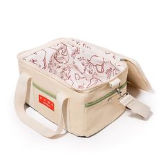 a small bag with an animal print on the front and side, sitting on top of a white surface