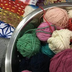 many balls of yarn are in a metal bowl