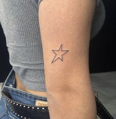 a woman with a small star tattoo on her arm