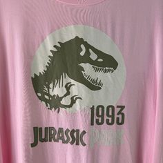 This Unique Vintage Jurassic Park T-Shirt Is A Must-Have For Any Fan Of The Iconic Movie Franchise. The Light Pink Color And Original Logo Make It A Perfect Addition To Any Collection. Made From A Comfortable Blend Of Spandex And Rayon, This Short-Sleeved Tee Features A Round Neckline And A Fitted Design That Flatters Any Body Type. Ideal For Women In Size 2x, This Basic Style T-Shirt Is Perfect For Casual Wear Or As Part Of A Costume For A Jurassic Park Themed Party. 1798 Jurassic Park T Shirt, Vintage Tee Shirts, Fitted Tee, Light Pink Color, Vintage Harley, Style T Shirt, Jurassic Park, Graphic Tee Shirts, Basic Style