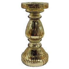 a gold colored candle holder on a white background