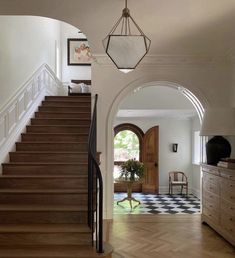 an entry way leading to a living room and dining room with wood flooring on the side