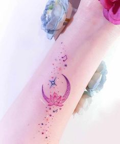 a woman's arm with a crescent and stars tattoo on the left side of her leg