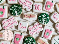 starbucks cookies decorated with pink and green icing on a white tablecloth that says happy birthday to you