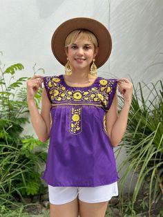 Mexican embroidered blouse, purple sleeveless top, khaki floral embroidery, fiesta fashion, summer vacation, southwestern maximalist boho Indulge in spirited game day style with this Purple and Yellow Game Day Top, a vibrant celebration of team pride and exquisite craftsmanship. Adorned with floral hand embroidery, this piece pays homage to LSU's Geaux Tigers and the bold hues of the Minnesota Vikings' color rush uniform. A nod to both collegiate and NFL fandom, this top is a statement of allegi Purple Casual Embroidered Top For Spring, Casual Purple Embroidered Top For Spring, Purple Floral Embroidered Top For Summer, Purple Floral Embroidery Top For Spring, Purple Embroidered Top With Floral Embroidery For Summer, Spring Purple Embroidered Cotton Top, Casual Purple Blouse With Floral Embroidery, Summer Purple Tops With Floral Embroidery, Casual Embroidered Purple Blouse