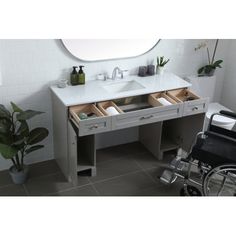 a bathroom vanity with two sinks and a wheel chair