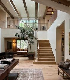 a living room filled with furniture and a staircase