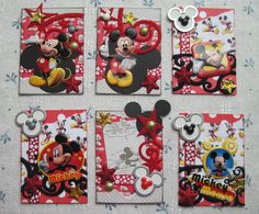 four different mickey mouse cards on a table