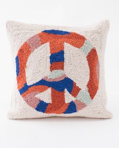 a peace sign pillow on a white background