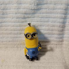 a small yellow and blue toy sitting on top of a towel