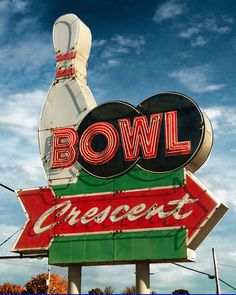 a bowling sign with a bowling ball on it's side and the word bowl crescent