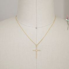 "Beautiful and lovely tiny gold color necklace featuring skinny gold cross pendent. Lobster clasp closure. Simple and warm. Gold plated brass necklace is perfect paired with any outfit . Your beautiful necklace will ship in a gift box. If you have any question, please feel free to contact me. Thanks :) ♥ Length 16\" chain ( if you need different length please contact us ) ♥ Cross pendent 1 1/4\" x 3/4\" ♥ Gold plated over brass ♥ Delivery Time Fast shipping within 1 - 3 days + See more Rudiana A Gold Crucifix Charm Necklace In Minimalist Style, Gold Minimalist Crucifix Charm Necklace, Minimalist Gold Crucifix Charm Necklace, Gold Cross Charm Necklaces In 14k Gold Filled, Gold Cross Necklace With Delicate Chain For Everyday, Everyday Gold Cross Necklace With Delicate Chain, Gold Delicate Cross Charm Necklaces, Delicate Gold Cross Charm Necklaces, Gold Cross Necklace For Everyday