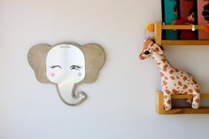 a giraffe and an elephant are on the wall