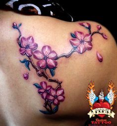 a woman's back with pink flowers on it