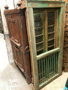 an old wooden window sitting on top of a floor