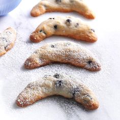 four cookies with chocolate chips and powdered sugar