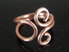 "OM style copper wire ring. Made from 14 gauge bare copper wire, it is filed, hammered and hand polished. This ring is simple yet contemporary. This minimalist copper ring is a nice gift for women. Bare Copper Ring. \"BUY NOW!\" The Healing Properties of Copper: Some wearers of copper jewelry find it relieves the symptoms of arthritis and circulation problems. COPPER IS A CONDUCTOR OF ENERGY. A perfect, meaningful gift for that special person. * Ring may be Adjusted to fit your finger perfectly! Copper Wire Ring, Soldered Jewelry, Wire Jewelry Rings, Casual Rings, Womens Ring, Wire Jewelry Designs, Wire Ring, Wire Wrapping Crystals, Diy Wire Jewelry