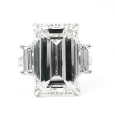 an emerald cut diamond ring with three baguetts