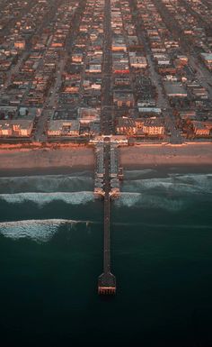 an aerial view of a city and the ocean