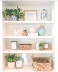 the shelves are filled with baskets and vases on top of them, along with other decorative items