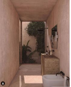 a narrow bathroom with two sinks and a bathtub in the middle of the room