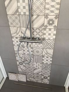 a shower with tiled walls and flooring in a bathroom