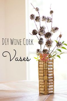 a vase filled with flowers sitting on top of a table next to wine corks